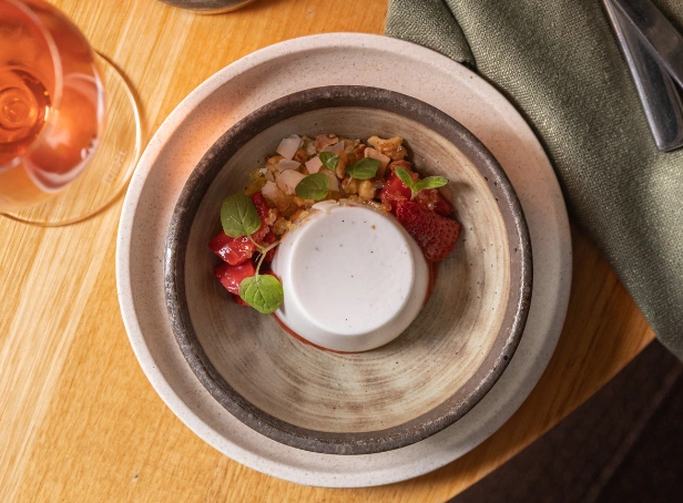 panna cotta dessert with fresh strawberries and crumble served at Esca Bimbadgen with glass of Moscato