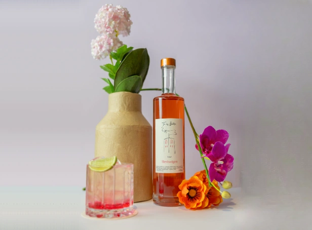 Bimbadgen Tu Es Belle Moscato bottle with cocktail glass and floral arrangement showcasing pink fortified Moscato