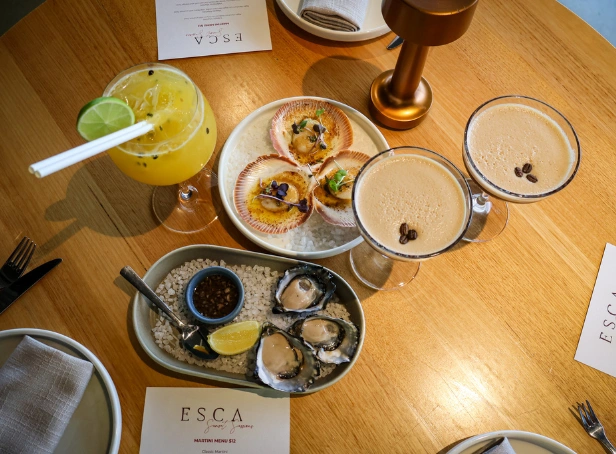 $12 martinis and cocktails with fresh oysters and scallops at Esca Bimbadgen balcony during Friday Martini Hour