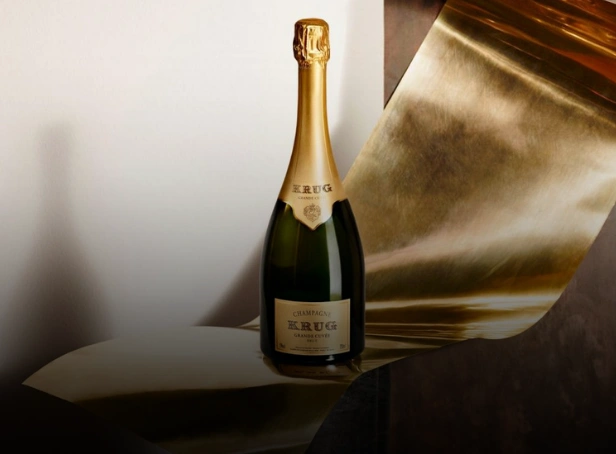 Bottle of Krug Grande Cuvée Champagne displayed against sculptural gold metallic textures for Esca Restaurant’s Champagne degustation dinner in the Hunter Valley.