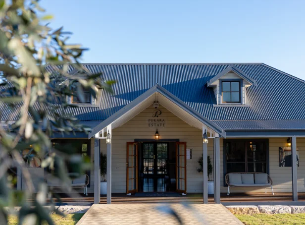 Pukara Estate’s Pokolbin tasting room entrance, with open timber doors, a covered verandah and outdoor seating.